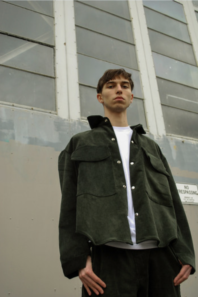 Look 02 — Olive field jacket against warehouse windows