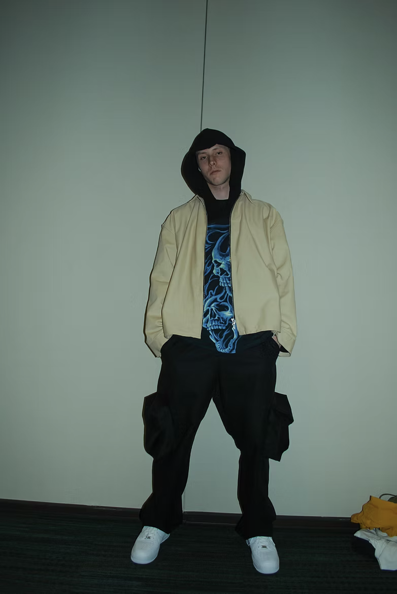 Cream jacket over graphic tee